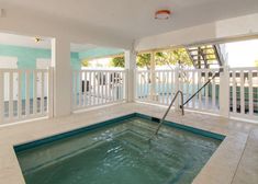 an indoor swimming pool with stairs leading up to it