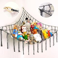 a bunch of stuffed animals are in a hammock hanging on the wall with hair clips