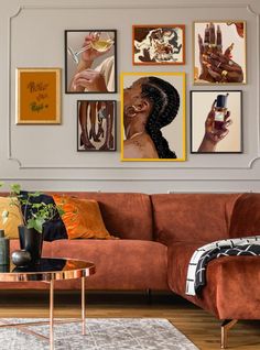 a living room filled with furniture and pictures on the wall