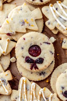 cookies with white icing and decorations are arranged on a table