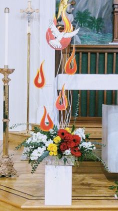 a church alter with flowers and candles on it