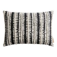 black and white striped pillow with fringes on the front, in an embroidered pattern