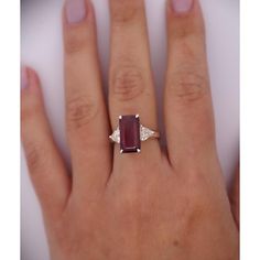 This dazzling 4.67-carat natural ruby looks stunning as the centerpiece of this ring. The ruby is emerald cut set in a classic 4-prong setting. The Platinum selected to hold this dazzling stone in place truly allows the ruby to shine. Standing to either side of the ruby are two trillion-cut diamonds, with a total weight of 0.82 carats.   Details: Item Type: Ring Metal: Platinum Size: 6.5 Weight: 5.75 Grams Setting: 4 Prong  Center Stone Details: Stone Type: Natural Ruby Carat: 4.67 Cut: Emerald Color: Red Setting: 4-Prong  Side Stones Details: Type: Natural Diamond Cut: Trillion Cut Color: White Carat: 0.82 Quantity: 2 Timeless Emerald-cut Ruby Ring, Gia Certified Baguette Cut Ruby Ring, Luxury Emerald-cut Ruby Ring, Gia Certified Emerald Cut Ruby Ring, Emerald Cut Ruby Ring With Diamond Accent Stones, Elegant Emerald-cut Solitaire Ruby Ring, Timeless Emerald Cut Ruby Ring, Emerald Cut Garnet Ruby Ring With Accent Stones, Lab-created Ruby Ring With Baguette Cut