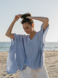 The perfect top to throw on with vintage Levi’s for running around town or doubles as an airy beach coverup. Made in a super soft cotton double gauze with raw edge trim. Takes you from beach to bar and from Summer to Fall. One Size Body length from shoulder 25.5” Body width flat 27” Delicate wash, tumble dry low *Raw edges are intentional on this garment. Please snip loose threads as necessary and wear with joy! Consciously made in small batches in sunny California using deadstock fabrics and re Breezy V-neck Tops For Beach, Relaxed Summer Tops With Frayed Hem, Breezy Relaxed Fit Top For Loungewear, Breezy Tops With Relaxed Fit For Loungewear, Relaxed Beach Cover-up Tops, Flowy Cotton Summer Cover-up, Blue Breezy Beach Tops, Blue Breezy Top For Beach, Breezy Blue Tops For Beach