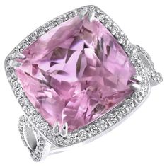 a pink diamond ring with diamonds around it