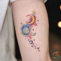 a woman's thigh with an image of the planets and stars tattoo on it