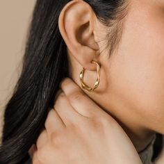 Our Ripple Hoop Earrings are inspired by the ripple effect that a pebble can cause in the ocean - these hoops stand as a reminder that you can have a ripple effect on the world with even the smallest action. Materials & Warranty Material: Real 18 karat gold plating on pure stainless steel Hypoallergenic | Sensitive Skin-Friendly Warranty: Lifetime Warranty against all rust or tarnish Packaging: Nominal Velvet Drawstring Pouch Earrings cannot be returned or exchanged due to hygienic safety The Ripple Effect, Ripple Effect, Drawstring Pouch, In The Ocean, Silver Hoop Earrings, Gold Plating, Sensitive Skin, The Ocean, Rust