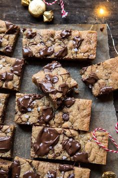 chocolate chip cookie bars with candy canes and christmas decorations on the table next to them