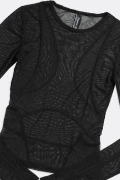 This item is subject to a 15% restocking fee if returned. A sheeru00a0mesh fitted long sleeve top withu00a0contour panels. Whatever your mood, spicy or sporty, wear this top at the gym or a night out on the town. Sheer perfection. u00a0 Content + Care \-u00a0Recycled Polyester Wash in cold water, hang dry Hand Made in Los Angelesu00a0 Size \-u00a0XS - 2XL One-of-a-Kind Vintage Authentic vintage piece, handpicked from around the world. One-of-a-Kind Vintage styles are singularly circular, extendi Sheer Nylon Tops For Fall, Chic Long Sleeve Nylon Mesh Top, Sheer Fitted Long Sleeve Top For Layering, Fitted Long Sleeve Top With Sheer Sleeves, Fitted Sheer Long Sleeve Top For Layering, Fitted Long Sleeve Mesh Top With Mesh Sleeves, Fall Nylon Mesh Top With Sheer Sleeves, Fitted Long Sleeve Nylon Mesh Top, Fitted Long Sleeve Top With Sheer Sleeves For Layering