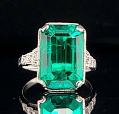 Vintage 14k white gold green emerald in a rectangular shape  center set lab grown green emerald weight 4.63ct. size 13.6x8.8mm very nice rich vivid green color  nice luster, very lively, and nice cut.  clean emerald brilliant, sparkly. side  set round cut diamonds total weight 0.08ct ring size 5 Resizable  Appraisal available  Retail value $6,500 net. Formal Green Emerald Ring With Rectangular Stone, Formal Rectangular Green Emerald Ring, Classic Emerald Ring With Rectangular Stone For Formal Events, Classic Emerald Ring With Rectangular Stone For Formal Occasions, Green Platinum Emerald Ring For May Birthstone, Classic Green Emerald Ring With Rectangular Stone, Formal Emerald Ring With Rectangular Stone, Classic Square Cut Emerald Ring, Platinum Emerald Ring With Radiant Cut