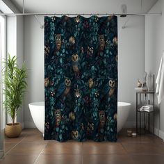 a shower curtain with an owl and leaves pattern on it in a bathroom next to a bathtub