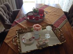 there is a tray with flowers and cups on it