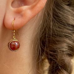 Red Acrylic Wrapped Gold Bead Earring made with gold iron wire wrapped delicately around a acrylic bead. All earrings here are crafted with love and care 🥰 These are the perfect earrings for a thoughtful gift or a way to treat yourself. The earrings are simple and designed to make you shine ✨ Single Round Beaded Earring As A Gift, Gift Round Beaded Single Earring, Red Copper Wire Wrapped Jewelry, Red Wire Wrapped Copper Jewelry, Red 14k Gold Filled Drop Earrings, Red 14k Gold Filled Earrings For Gift, Gold Copper Wire Earrings As Gift, Gold Copper Wire Earrings For Gift, Wire Wrapped Beaded Dangle Earrings For Gift