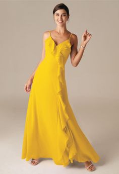 a woman in a yellow dress posing for the camera with her hand on her hip