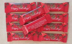 six red candy bars with happy holidays written on them