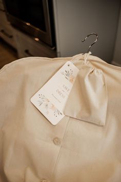 a dress shirt is hanging on a hanger in front of a stove and oven