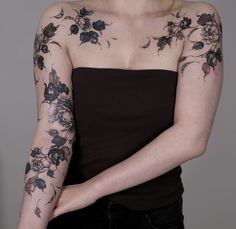 a woman with tattoos on her arm and shoulder