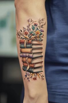 Stack of books tattoo with flowers on a forearm. Literature Sleeve Tattoo, Old Book Tattoo, Colorful Book Tattoos, Book Stack Tattoo, Stack Tattoo, Book Sleeve Tattoo, Antique Tattoos, Antique Tattoo Ideas