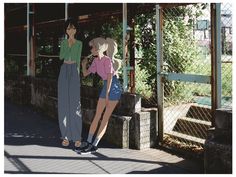 two young women standing next to each other in front of a metal structure with trees