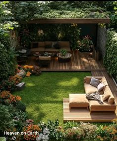 an outdoor living area with grass and wooden furniture in the center, surrounded by plants