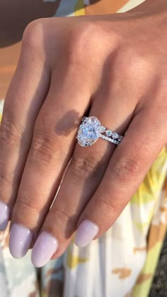 a close up of a person's hand with a ring on their finger and nails