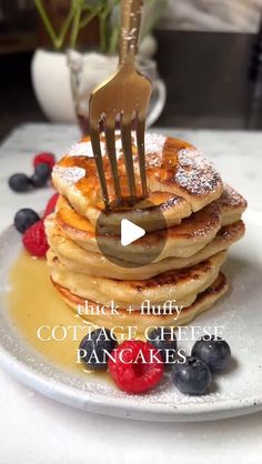 a stack of pancakes on a plate with a fork stuck in it