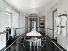 an elegant bathroom with marble floors and walls