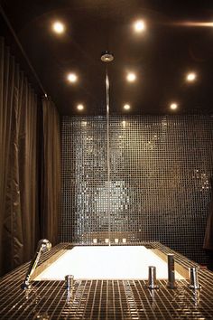 a bathroom with a large tub and lights on the ceiling