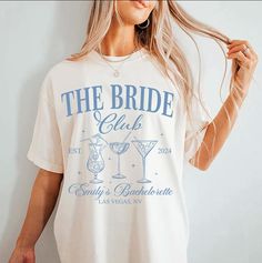 a woman wearing a t - shirt that says the bride club and has a martini glass on it