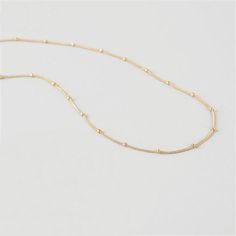 This simple, tiny, short beaded chain necklace is the perfect base to start layering your necklaces. It's very short, but not quite choker length, so it won't get lost within your other pieces. However, this is also a great necklace to wear alone with a higher collar dress or tee! It lays beautifully on top of your collar bone. *Please keep in mind that this necklace will be a little shorter or longer on your depending on the circumference of your neck. DETAILS & SIZE Composition: 18K gold p Minimalist Beaded Chain Layered Necklace, Minimalist Everyday Beaded Chain Layered Necklace, Minimalist Beaded Necklaces With Adjustable Chain, Minimalist Adjustable Chain Necklace With Round Beads, Minimalist Adjustable Ball Chain Necklace, Minimalist Adjustable Round Bead Chain Necklace, Dainty Beaded Chain Necklaces For Layering, Minimalist Ball Chain Necklace With Round Beads, Minimalist Chain Necklace With Adjustable Chain And Round Beads