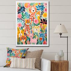 a living room with a white couch and colorful art on the wall above it's head