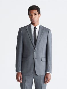 A refined look with tailored, slim fit shaping, this Calvin Klein blazer jacket is made from four-season wool with natural stretch and a subtly textured design. Lightly padded shoulders, notch lapels, a 2-button front, 4-button cuffs and multiple front pockets finish this timeless yet modern look.  Material: 100% Wool. Grey Suit Jacket, Grey Suit, Gray Suit, Textured Design, Jacket Buttons, Sport Coat, Blazer Jacket, Heather Grey, Suit Jacket