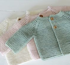 four knitted sweaters sitting next to each other