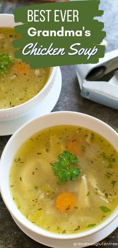 two white bowls filled with chicken soup on top of a table