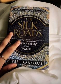 the silk roads by peter frankopian is shown in this hand - held photo