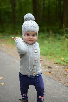 "This cute kids beanie is perfect accessory for any children outfit for all occasions. Your child is ready to look cute in this delightful, soft and comfortable hand knitted gray beanie with ear flaps decorated with cables throughout the hat. The hat is made of 100% merino wool for a stretchy and comfortable fit. Merino wool is breathable and active fiber that reacts to changes in body temperature and discourages sweating. Sizes of this beanie are according the circumference of the head or age. Cute Warm Beanie In Acrylic Yarn, Cute Warm Acrylic Yarn Beanie, Cute Knitted Acrylic Beanie, Cute Hand Knitted Winter Bonnet, Cute Adjustable Knit Beanie, Cute Warm Knit Beanie, Cute Warm Knit Crochet Hat, Cute Warm Crochet Knit Hat, Cute Knitted Bonnet Cap