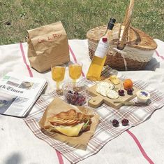 a picnic blanket with food and drinks on it