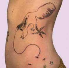 a woman's stomach with an animal tattoo on her side and the bottom part of her body