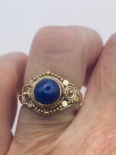 Blue lapis lazuli cocktail ring  Lovely vintage golden bronze setting Size 6  Our jeweler can custom re size this for a $20 fee.  All rings are shipped in a nice gift box.   Check out our over a THOUSAND great reviews Engraving is $4 per letter and is not always perfect depending on the piece. It can take a few days if the jeweler is busy. This is payable to Paypal Judithsltd@gmail.com Antique Blue Brass Jewelry, Blue Brass Jewelry For Anniversary, Cabochon Brass Rings As Gift, Bohemian Sapphire Rings For Gifts, Bohemian Sapphire Ring For Gift, Bohemian Sapphire Ring As A Gift, Blue Brass Ring Jewelry, Gold Lapis Lazuli Ring As Gift, Gold Lapis Lazuli Ring For Gift