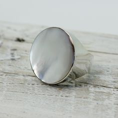 "Elegant white Mother of pearl round ring set on 925 sterling silver with a gorgeous genuine white mop cap quality jewelry solid quality work Dimensions Length x Width : 26 x 26 mm Weight 12.3 grams Colors : WHITE PEARL MOP RING SIZING is available if you need a bigger or smaller size choose option \"Ring + Resizing\" and put option in message box.  For resizing it takes 5 to 7 days before shipping / $20 usd done by laser" Minimalist Silver Pearl Ring With Polished Finish, Elegant Mother Of Pearl Round Rings, White Mother Of Pearl Wedding Ring, White Mother Of Pearl Round Pearl Ring, Minimalist Silver Mother Of Pearl Jewelry, Classic Mother Of Pearl Ring As A Gift, Classic Mother Of Pearl Ring For Gift, Classic Mother Of Pearl Ring As Gift, Classic Mother Of Pearl Round Rings