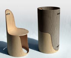 two wooden chairs sitting next to each other