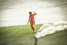 a woman on a surfboard in the water