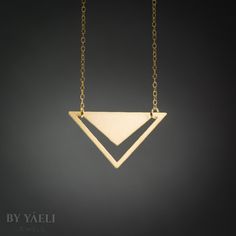 Triangle necklace - geometric triangle with V-shaped hole pendant. Featuring minimalist  silhouettes. ★ Comes in our signature gift box, ready for gift giving.  ★ Available in Gold [ gold-filled chain & gold plated brass pendant]  ★ Pendant size: 1.10"X1.80" Thanks for shopping at ByYaeli♥  All images, texts & products are property of ByYaeli ©2020 Minimalist Pyramid-shaped Jewelry For Gifts, Minimalist Triangle Brass Jewelry, Minimalist Gold Triangle Jewelry, Minimalist Triangle Gold Jewelry, Gold Geometric Minimalist Necklace, Minimalist Gold Geometric Necklace, Minimalist Geometric Gold Jewelry, Minimalist Geometric Necklaces For Everyday, Gold Triangle Necklace For Gift