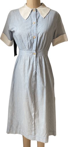 1930's blue & white checkered baby nurse dress. 9.5" sleeve14.5" shoulder to shoulder21" bust across14" waist across42.5" length Classic Gingham Dress For Work, Fitted Classic Plaid Dress With Short Sleeves, Classic Fitted Plaid Dress With Short Sleeves, Fitted Gingham Plaid Dress For Daywear, Classic Gingham Short Sleeve Dress, Classic Short Sleeve Gingham Dress, Fitted Collared Gingham Dress, Fitted Gingham Dress With Collar, Classic Gingham Dress With Short Sleeves