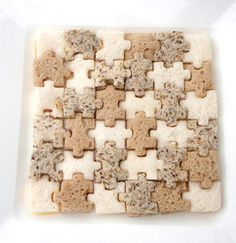 a white plate topped with lots of cut up pieces of bread next to each other