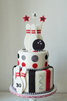 a cake decorated with bowling pins and balls