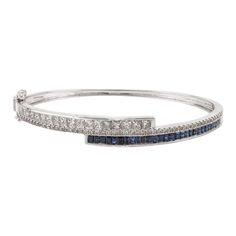 This is part of Chairish’s Fine Jewelry assortment.  This Brilliant Diamond and Blue Sapphire Cuff Bracelet in 18K gold showcases endlessly sparkling natural blue sapphire of 1.47 carats and 2 carats diamonds. Sapphire stimulates concentration and reduces stress.  Designed with perfect baguette cut blue sapphire and square cut diamonds studded in it to make you stand out on any occasion or event. The elegant style complements the attire beautifully and is a perfect Engagement Gift, Bridal Shower Fine Sapphire Bangle Jewelry, Fine Jewelry Sapphire Bangle Bracelet, Luxury Sapphire Bangle Bracelets, Luxury Sapphire Bangle Bracelet, Brilliant Cut Sapphire Diamond Bracelet In Fine Jewelry Style, Sapphire Diamond Bracelet With Brilliant Cut, Sapphire Brilliant Cut Diamond Bracelet, Elegant Blue Diamond Bangle, Sapphire Bangle Bracelet For Formal Occasions