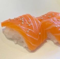 two pieces of sushi on a white plate