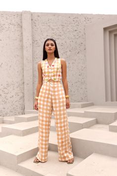 Edgy and easy-going, our block printed two piece co-ord set is a wardrobe staple you can’t miss out on.Hand block printed in Jaipur, Rajasthan.Made in soft modal cotton satin.Cropped waistcoat features a boxy silhouette and V neckline. The waistcoat is adorned with crocheted flowers and gold beads.Pants feature an elasticated back waist and front zipper. Highlighted with front hip pockets.Styling Tip- Style it with a tote bag and statement jewellery to ace that look. soft modal Cottonsatin 1 ski Cropped Waistcoat, Half Jacket, Shirt Jacket Men, Tunic Designs, Drape Saree, Coord Set, Crocheted Flowers, Statement Jewellery, Silk Roses