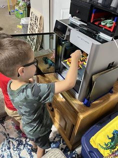 a young boy playing with an electronic device